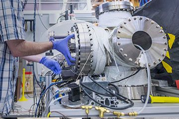 Scientist adjusting the 9.4 Tesla FT-ICR MS 155mm