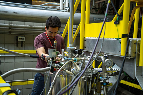 MIT physicist Kevin Nuckolls works at the top of a magnet.
