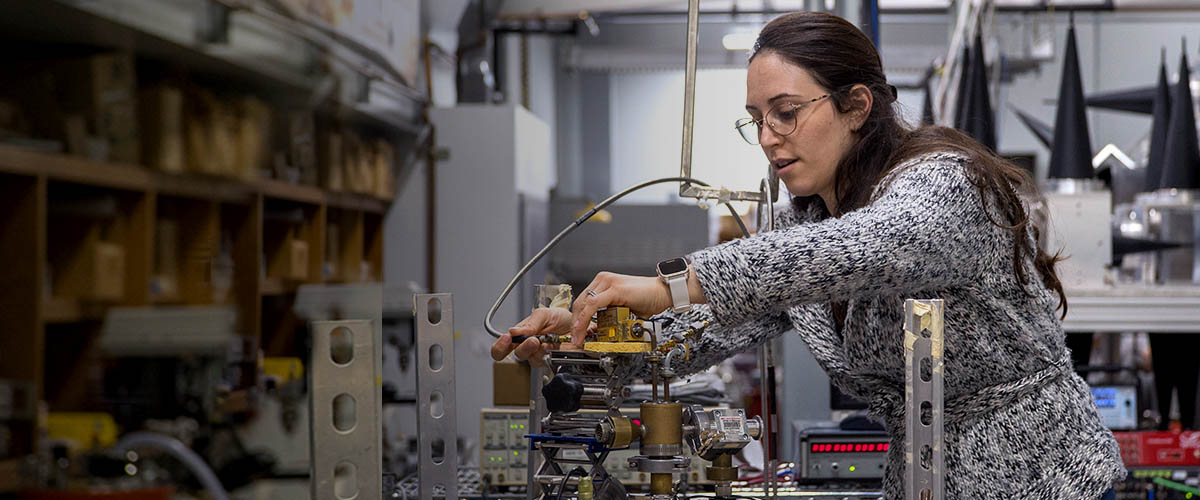 Scientist adjusting a magnet in the HiPER system