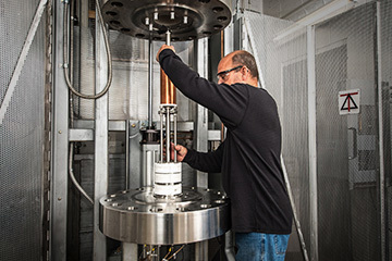 MagLab Engineer loading a magnet coil into a furnace