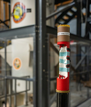 The specialized MRI coil for lithium-ion batteries attached to a specialized probe, ready to be placed into the main magnet for scanning.