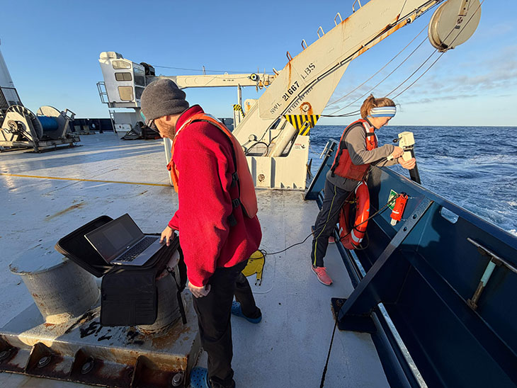 Deploying an instrument called an XBT to take temperature readings.