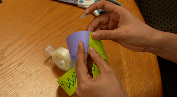 Taping the ends of the paper together