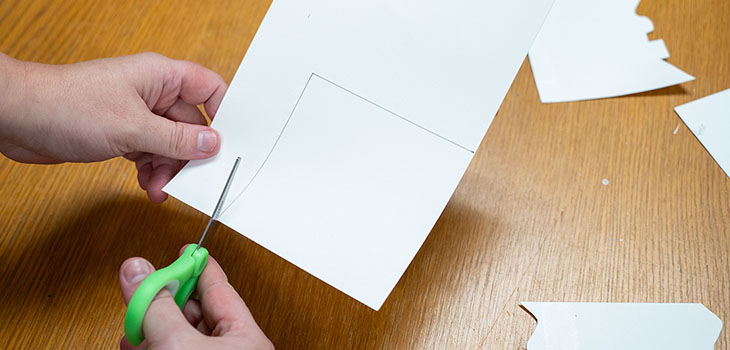 A person is cutting a square